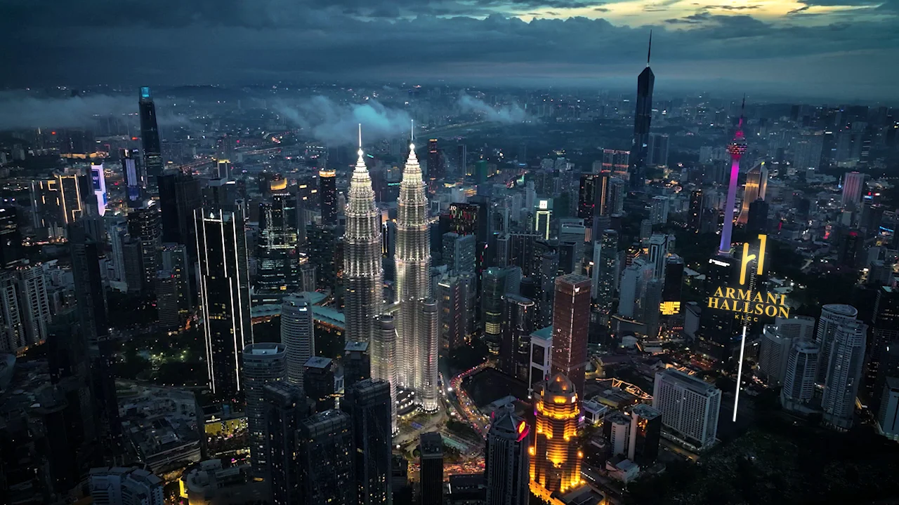 Armani Hallson KLCC — aerial drone view of the Kuala Lumpur skyline at dusk, showing the site location